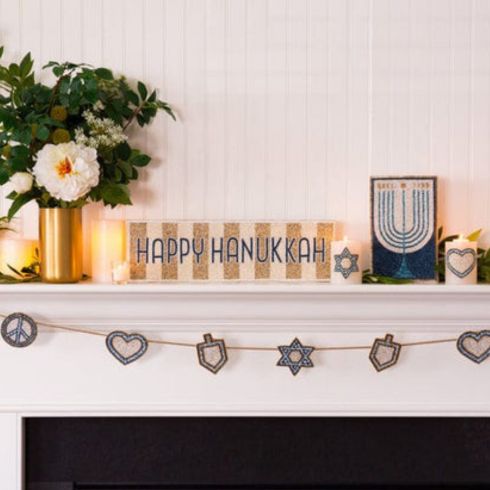 Beaded Hanukkah sign on fireplace mantel