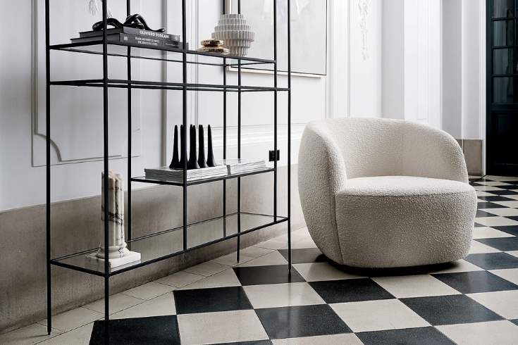 White boucle couch with black shelf and black and white floors