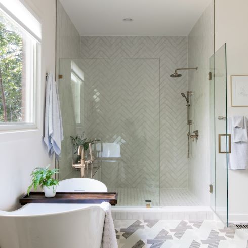 Crisp monochromatic bathroom with stand-up shower and soaker tub