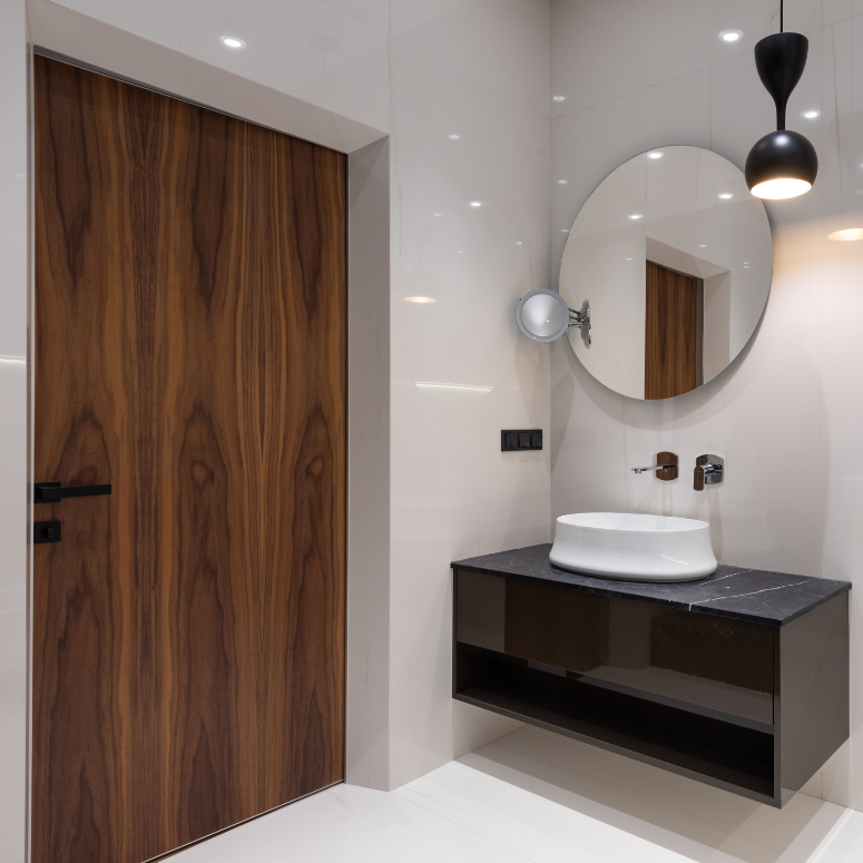 Dark wooden door in sleek modern bathroom