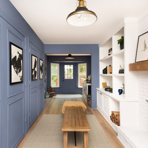 Mudroom with blue walls and bench
