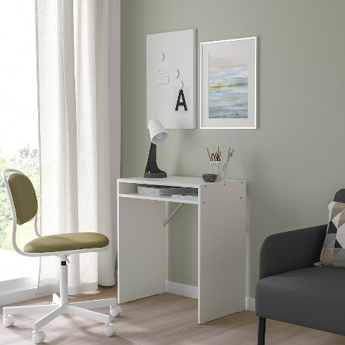 The white Torald IKEA desk in a green room with green office chair
