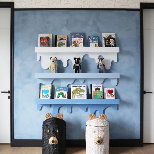 Shelves in kids' room against blue lime wash wall
