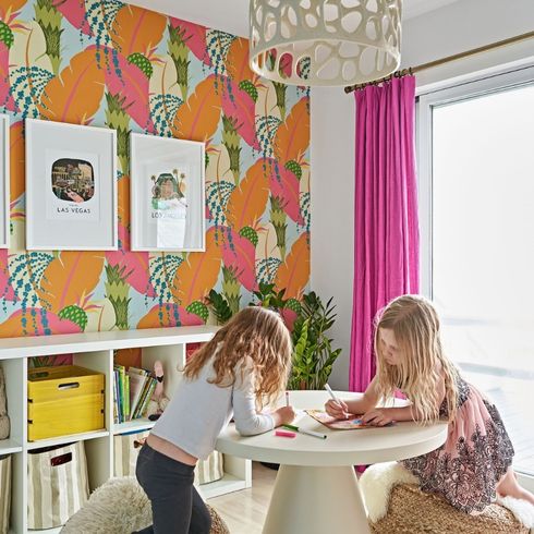 Patterned wallpaper in kids' room with art table