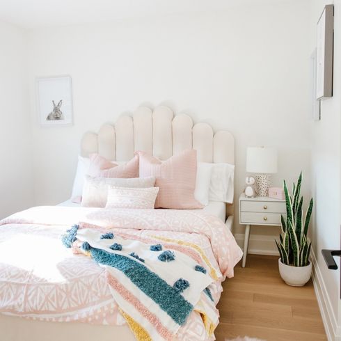 Pink kid's bedroom with fabric headboard