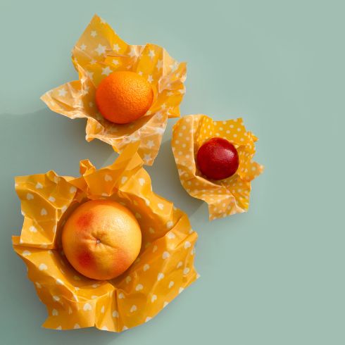 Beeswax wrap over three pieces of fruit