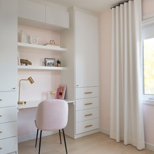 Built-in desk in kid's room with pink accents