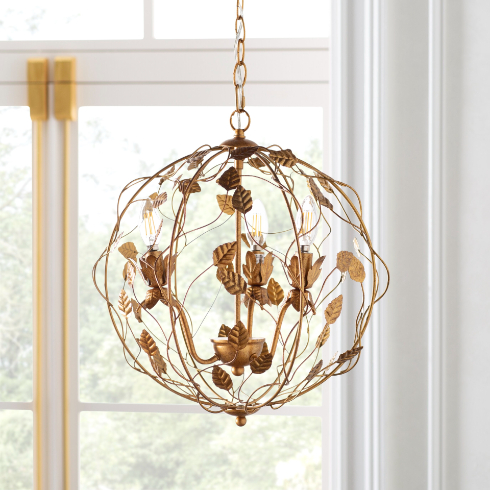A gold globe chandelier with gold leaf design