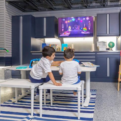 Kids in a clean and organized garage with a desk
