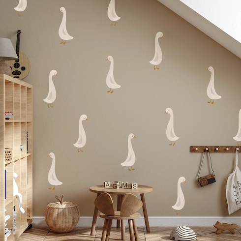 Cute Geese Wall Decals in a neutral playroom with tan-coloured walls, a partition shelf unit, play table and wall hooks.