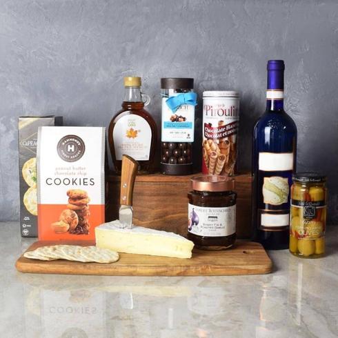 a basket of wine, cheese and gifts