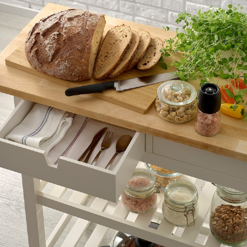 The IKEA FÖRHÖJA kitchen cart with open drawer and bread cut on top