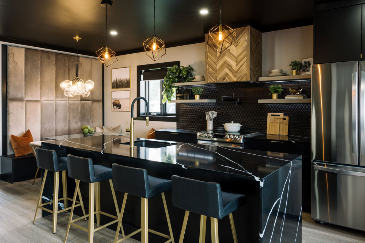 Dark marble island counter in a renovated kitchen