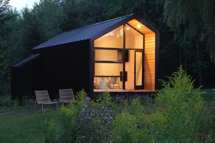Black tiny home in the woods