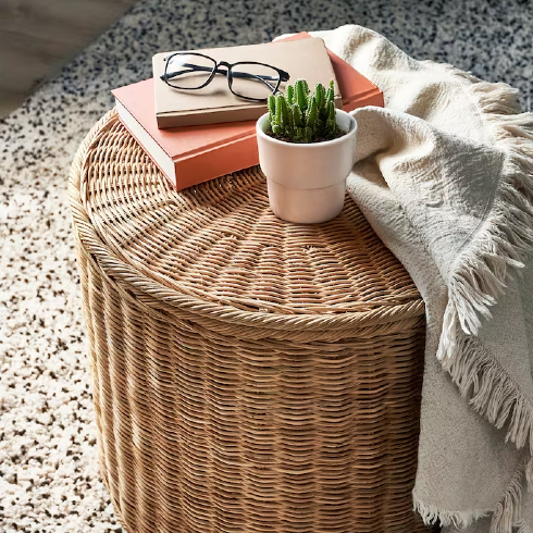 A rattan ottoman used as a table with storage