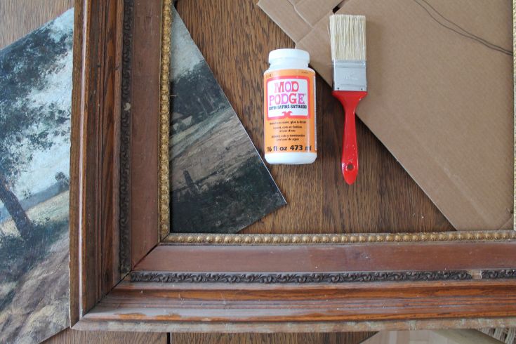 Mod podge and paint brush, antique print and antique frame. 