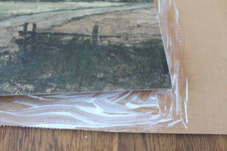 close up of mod podge and antique print for faux oil painting hack 
