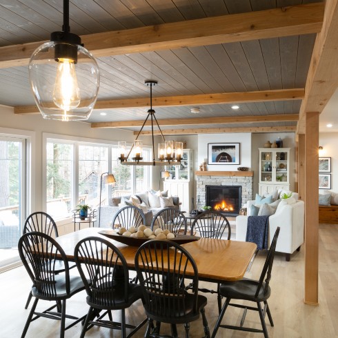 Dining room with black chairs under exposed beams
