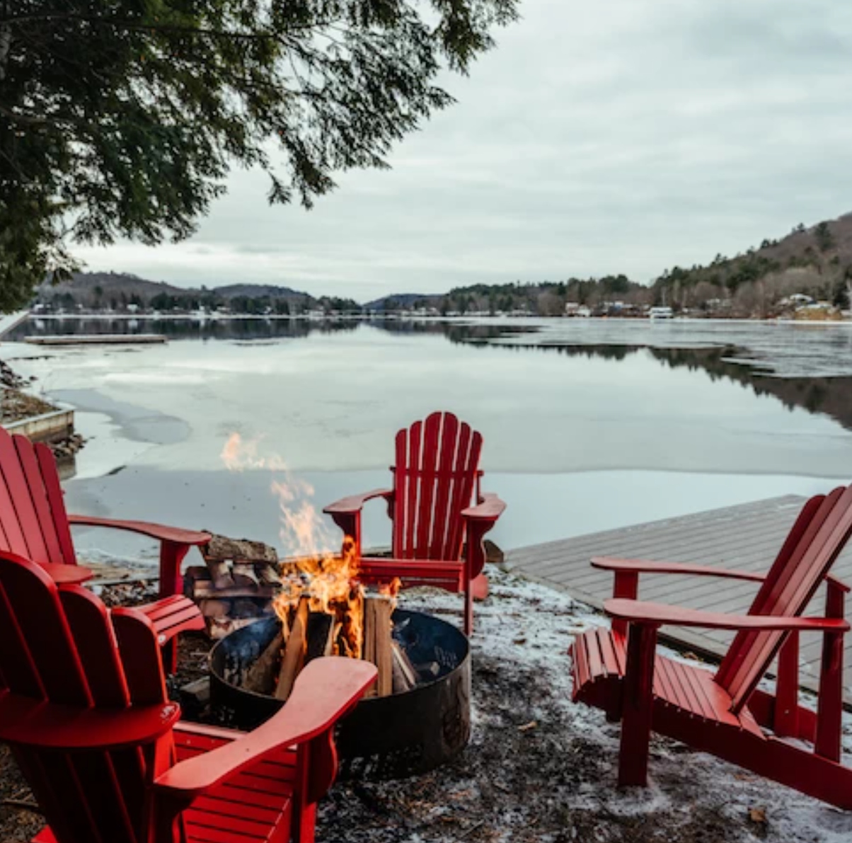 Red Muskoka chairs around fire pit at a second home property