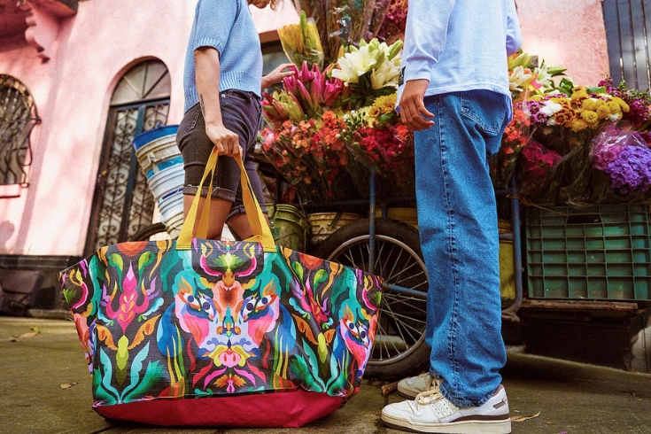 Big bright colourful bag held by a woman