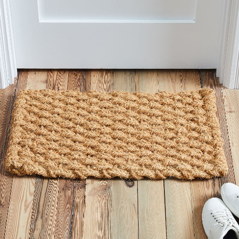 A solid woven front door mat