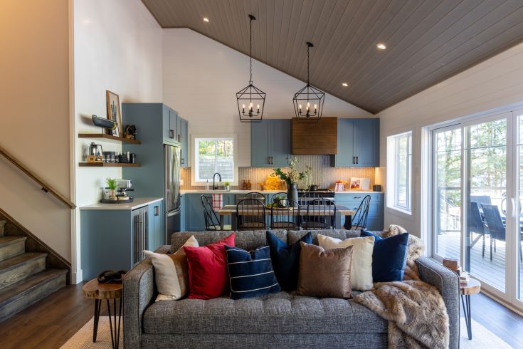 Open concept kitchen/dining space with bluish grey cabinets.