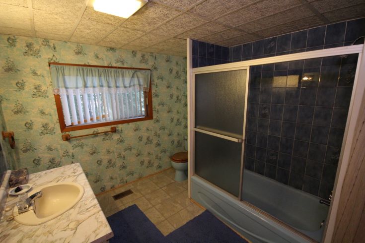 Outdated bathroom with excessive shades of blue.