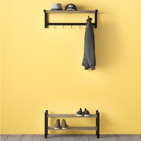 entryway storage ideas: Black hat rack yellow wall