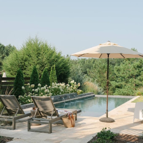Peaceful pool with umbrella - backyard wellness trends