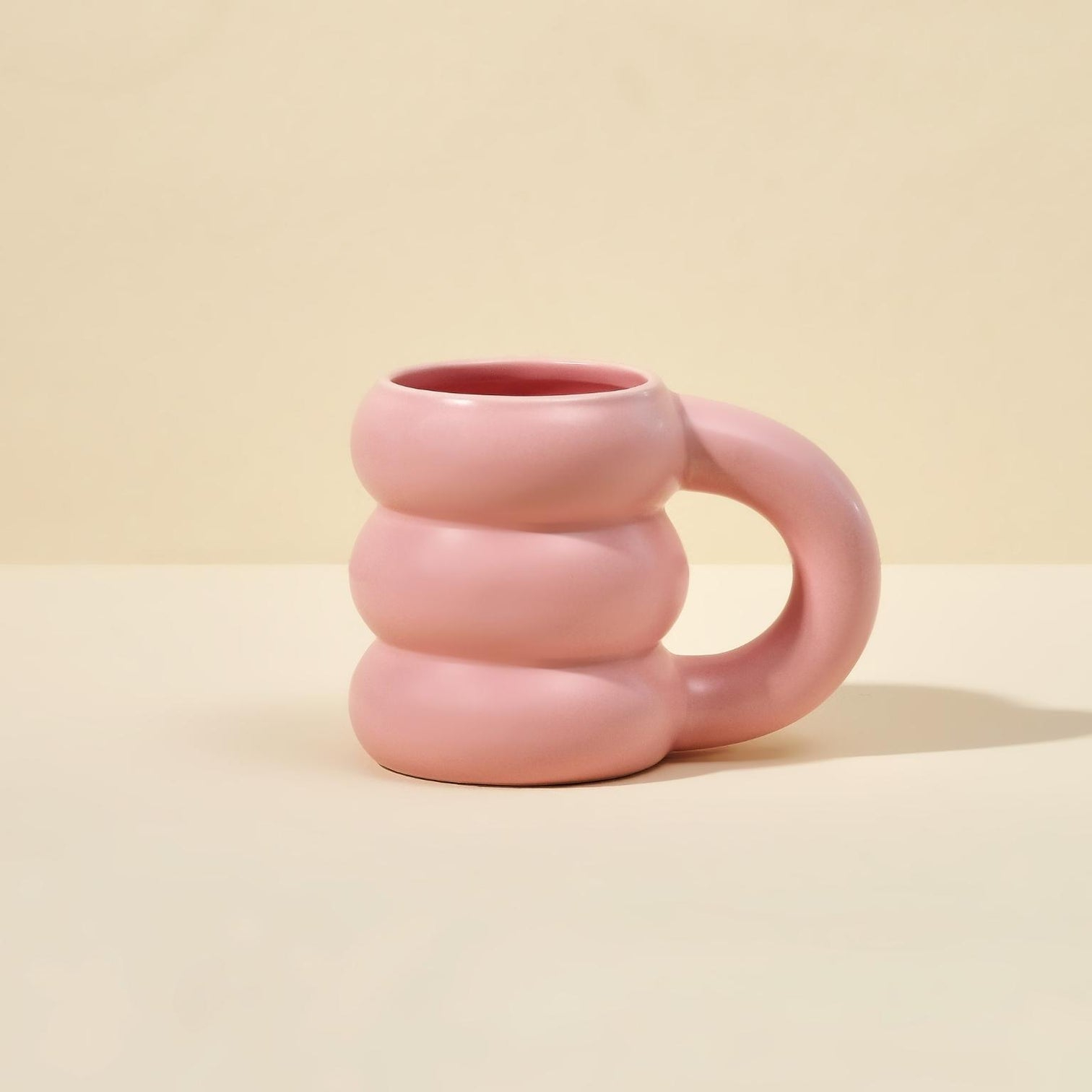 A shot of a pink cloud mug on light yellow background - graduation gifts for friends