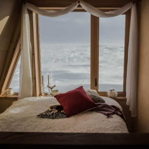 The front bedroom and window view in the Viking tiny home