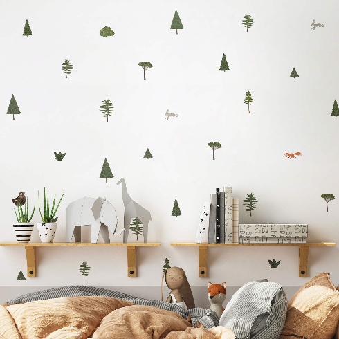 A white nursery room with evergreen tree wall decals