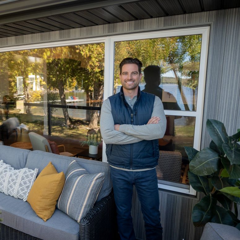 Scott McGillivray standing on the deck of a family friendly cottage