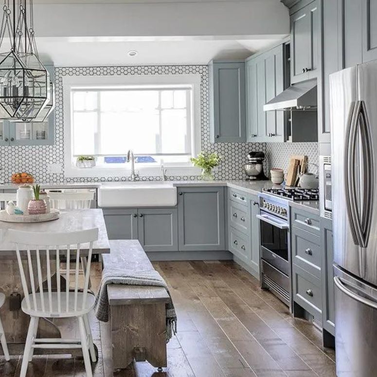 grey farmhouse style kitchen with wood floors and farmhouse sink