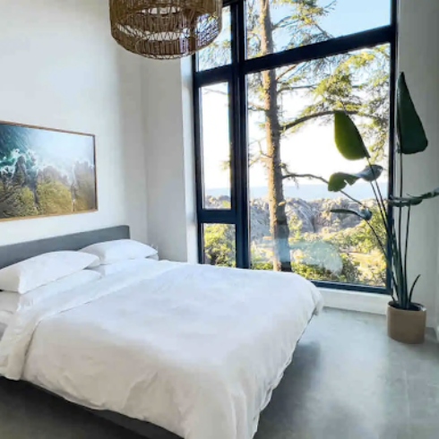 Bedroom with large window of Pacific Coast