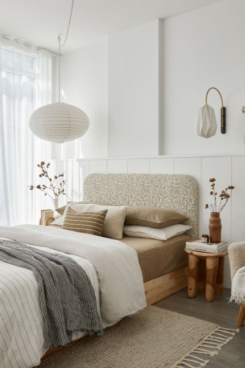The neutral and classic bedroom of the cozy Corktown condo