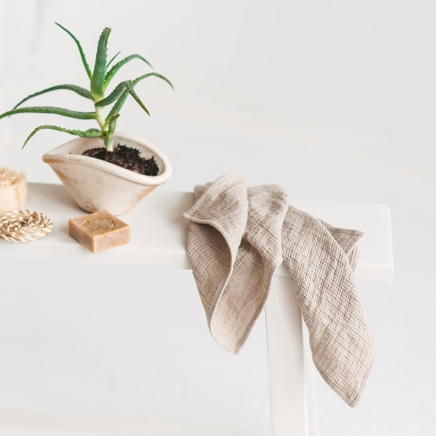 A pair of neutral-toned, waffled hand towels.
