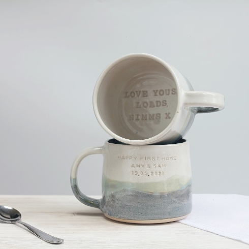 A pair of personalized, hand-made ceramic mugs