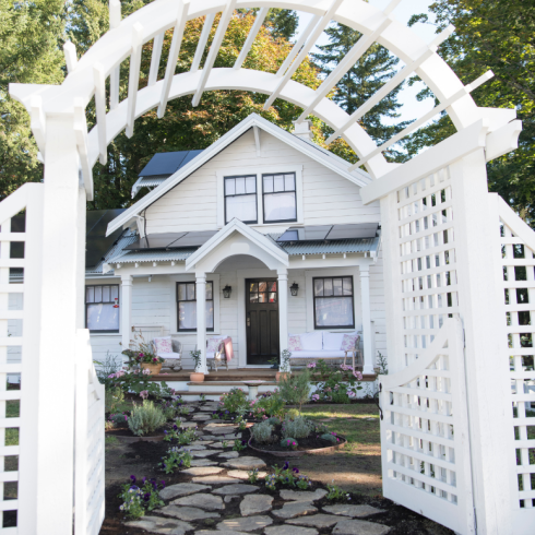 Pretty white arched trellis in front of house