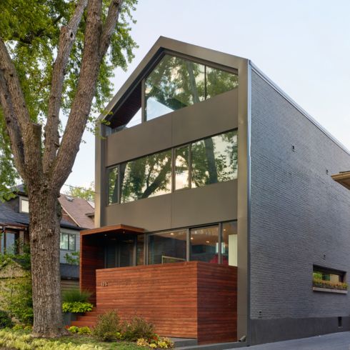 Contemporary house with privacy fence in the front