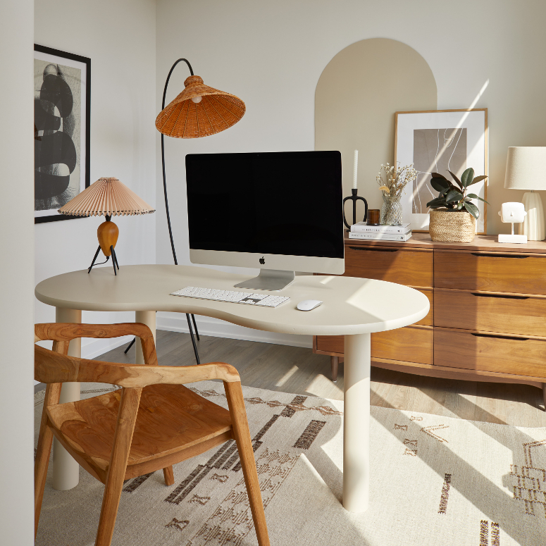 A shot of a cozy Corktown Toronto apartment's home office with neutral colours and quirky furniture