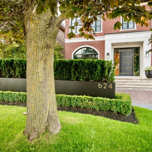 House with curb appeal showcasing modern planter and address numbers