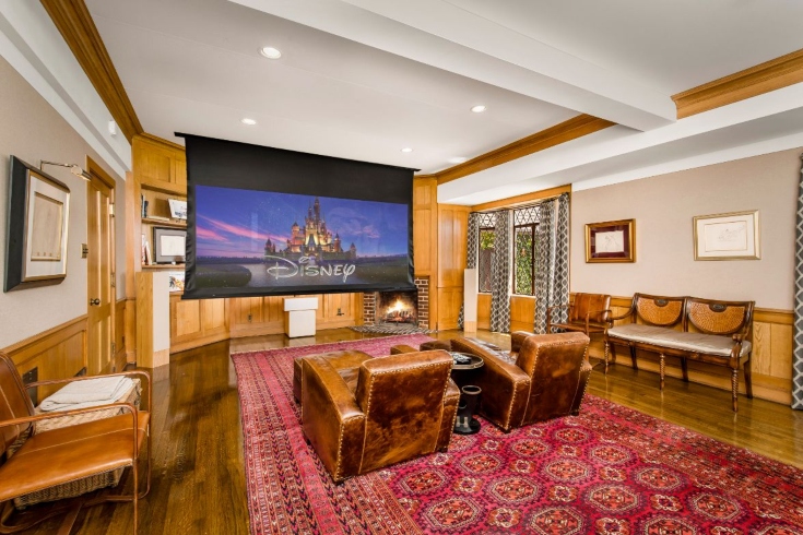 The home theatre in Walt Disney's Los Feliz home, with large armchairs and a large screen TV