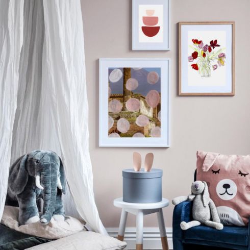 A gallery or collage of artwork in a kid's room