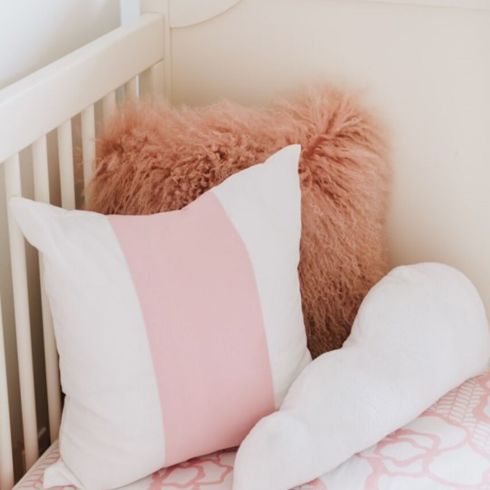 Pile of pillows in a crib