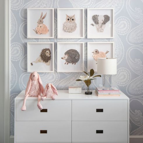 Dresser in baby's room with artwork