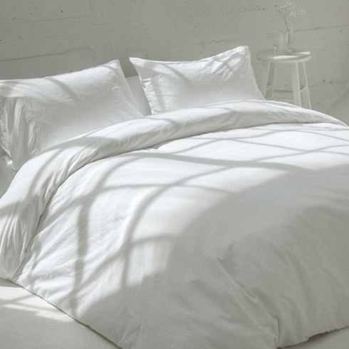White sheets on a comfy bed.