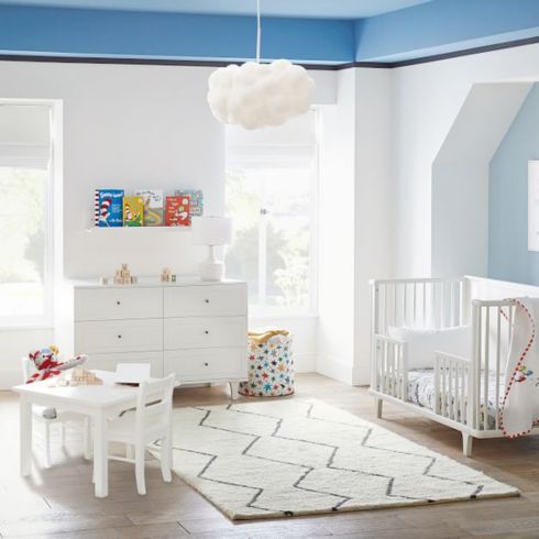 Fluffy cloud-shaped pendant light in blue boy's nursery room.