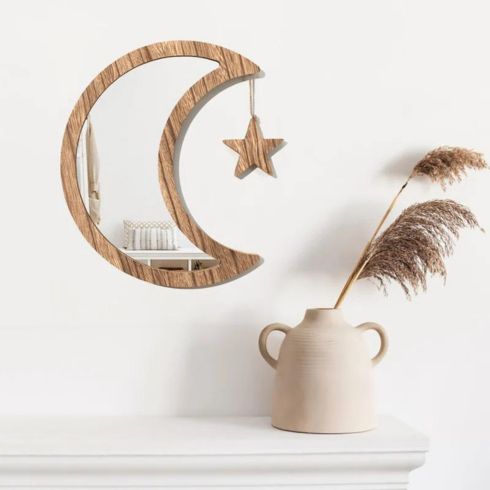 crescent moon shaped wood mirror with dangling star.