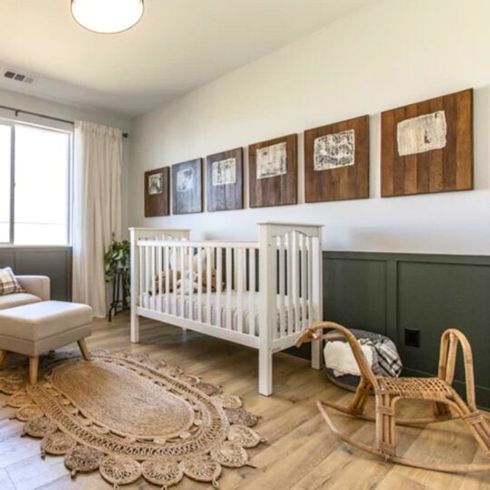 Green and neutral baby nursery room with wood and wicker accents.